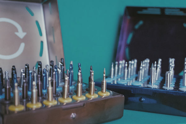 Two open drill boxes on a turquoise background.